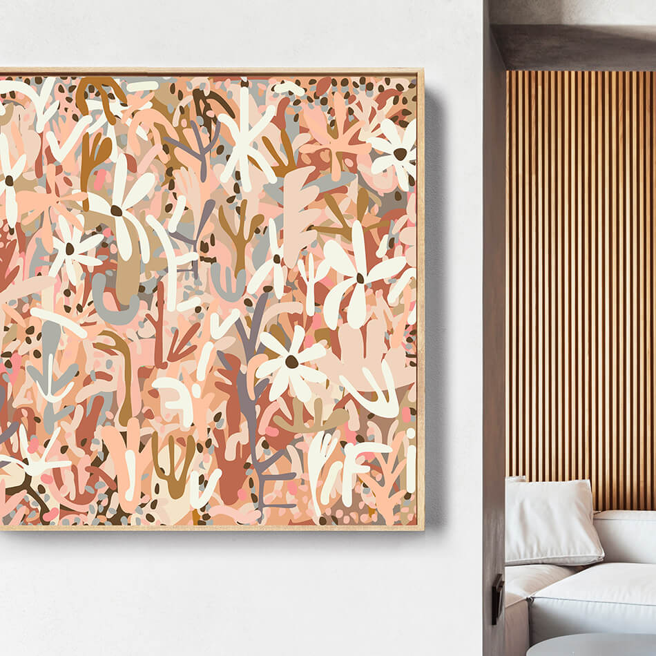 Abstract floral artwork in a wooden frame on a white wall with a modern interior setting.