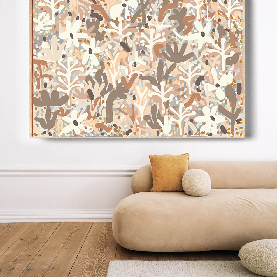 Abstract art piece on a wall above a beige sofa with a yellow pillow.